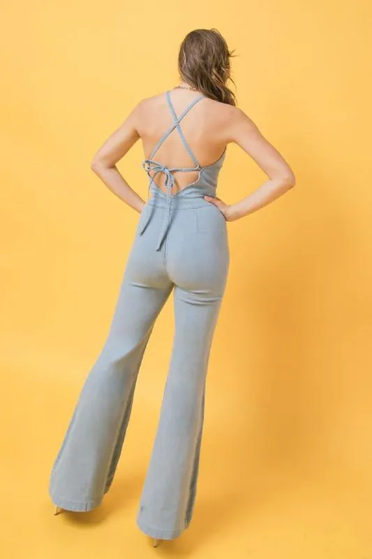 denim jumpsuit featuring halter neckline, flare pant