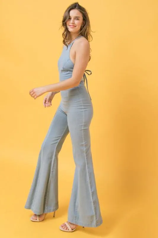 denim jumpsuit featuring halter neckline, flare pant